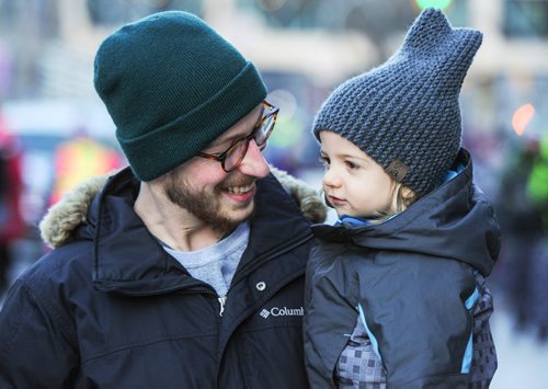 Josh and Ellias Cook share a moment while they await the start of the 2017 Santa Claus Parade Saturday night. November 18, 2017 Mike Sudoma / Winnipeg Free Press