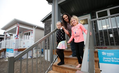 WAYNE GLOWACKI / WINNIPEG FREE PRESS

Todd Gauthier and his daughters, Chloe, left, and Carmin outside their Habitat for Humanity home on Lyle St. after receiving the keys at the  official ceremony Monday morning. Bill Redekop story   Nov. 20  2017