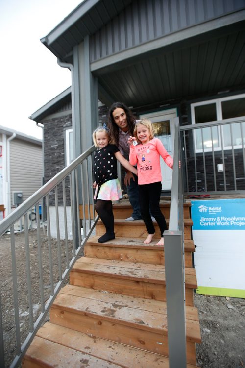 WAYNE GLOWACKI / WINNIPEG FREE PRESS

Todd Gauthier and his daughters, Chloe,left, and Carmin outside their Habitat for Humanity home on Lyle St. after receiving the keys at the  official ceremony Monday morning. Bill Redekop story   Nov. 20  2017