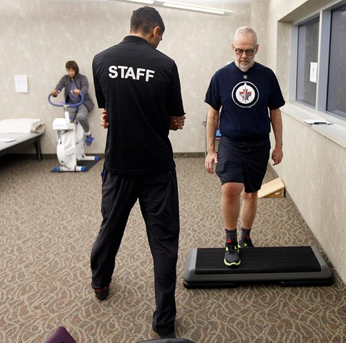 PHIL HOSSACK / WINNIPEG FREE PRESS  - Knee replacement patient Keith Hildahl works the step under the watchfull guidance of Physoitherapist Amandev Dhesi at the Reh-Fit Monday. Shanti Temull works her knee on the stationary bike in the background.  See Jane Gerster's story re: Group Physiotherapy.   - November 20, 2017