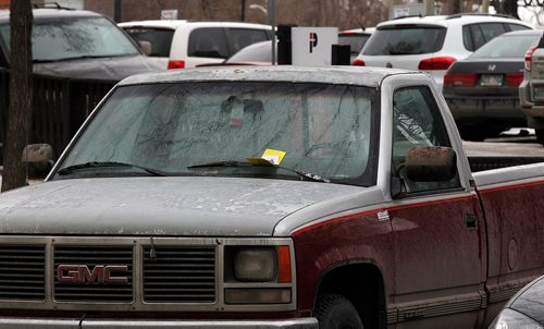 PHIL HOSSACK / WINNIPEG FREE PRESS  - Parking Politics - A trucked backed in the an angle parking spot on Bannatyne with a ticket, a surface lot behind is full with daily parkers..    - November 20, 2017