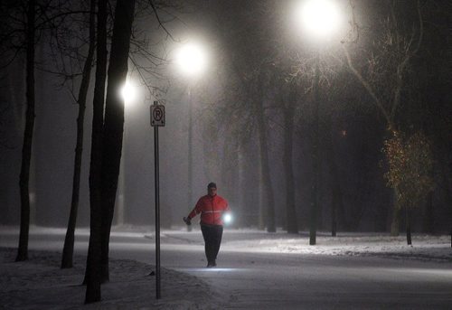 PHIL HOSSACK / WINNIPEG FREE PRESS  - WEATHER STAND-UP - A dedicated walker flashlight in hand makes her way around East Kildonan Park as dropping temperatures and snow fall over the city.    - November 20, 2017