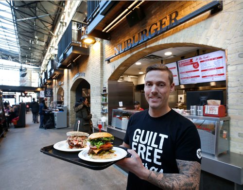 WAYNE GLOWACKI / WINNIPEG FREE PRESS

 Marc Priestley, co-owner of Nuburger, at their kiosk on the main floor of The Forks Market building next to the central Food Mall. Nuburger, with its selection of heathier gourmet burgers, is one of the new food vendors who have been recruited by the The Forks. Murray McNeill story.  Nov. 21  2017