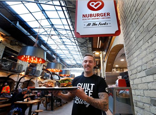 WAYNE GLOWACKI / WINNIPEG FREE PRESS

Marc Priestley, co-owner of Nuburger, at their kiosk on the main floor of The Forks Market building next to the central Food Mall. Nuburger, with its selection of heathier gourmet burgers, is one of the new food vendors who have been recruited by the The Forks. Murray McNeill story.  Nov. 21  2017