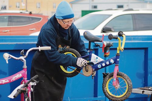 Canstar Community News Nov. 14, 2017 - Lynn Scott, a volunteer with The WRENCH, fixes a kids bike. (LIGIA BRAIDOTTI/CANSTAR COMMUNITY NEWS/TIMES)