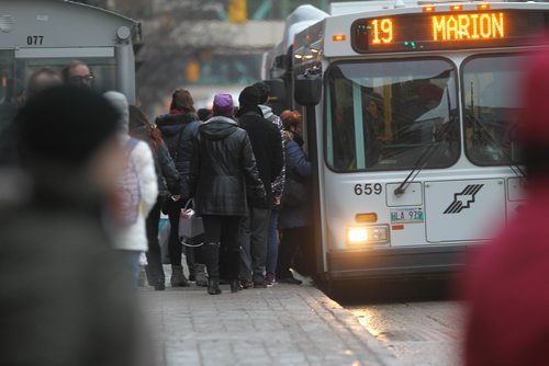 RUTH BONNEVILLE / WINNIPEG FREE PRESS

Transit fares will rise after the mayor tabled the City budget today.  Generic Photos of people getting on the bus in downtown Winnipeg.  
See story.  
Nov 22, 2017