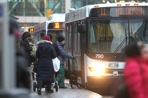 RUTH BONNEVILLE / WINNIPEG FREE PRESS

Transit fares will rise after the mayor tabled the City budget today.  Generic Photos of people getting on the bus in downtown Winnipeg.  
See story.  
Nov 22, 2017