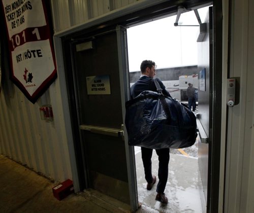 PHIL HOSSACK / WINNIPEG FREE PRESS  -  Winnipeg Blues defenceman Nick Cicek slips out the arena's back door to a waiting bus at the Iceplex Wednesday heading to Steinbach for a game. See Mike McIntyre's feature on team travel costs.... - November 22, 2017
