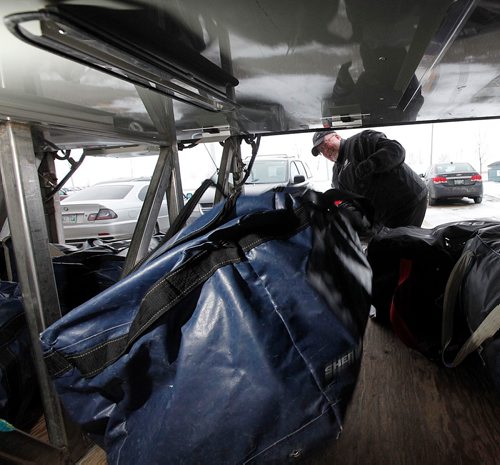 PHIL HOSSACK / WINNIPEG FREE PRESS  -  Driver Ray Lodders stacks duffle bags for the blues in the cargo hold of his Beaver Bus Lines charter to Steinbach for a game. See Mike McIntyre's feature on team travel costs.... - November 22, 2017