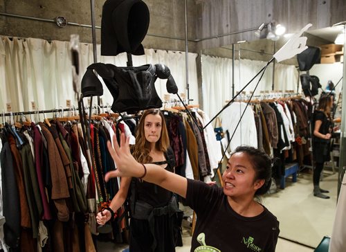 MIKE DEAL / WINNIPEG FREE PRESS
Eva Kuo, Properties Builder, from the prop department gets actress Lindsay Johnson to test out the movement of the arms with the frame of the Ghost of Christmas Future costume during a wardrobe fitting. A behind the scene look during the preparation for the Royal Manitoba Theatre Centre's production of A Christmas Carol.
171108 - Wednesday, November 08, 2017.