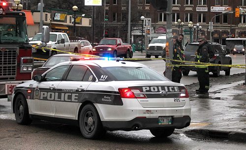 PHIL HOSSACK / WINNIPEG FREE PRESS  -  Friday afternoon. Two cars were left at the scene on Osborne. Police advise the road will be closed for some time while they investigate. Firefighters survey the scene of an accident at Roslyn Rd and Osborne   - November 24, 2017