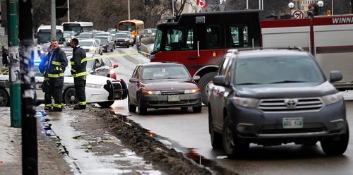 PHIL HOSSACK / WINNIPEG FREE PRESS  -  Friday afternoon. Two cars were left at the scene on Osborne. Police advise the road will be closed for some time while they investigate. Firefighters survey the scene of an accident at Roslyn Rd and Osborne   - November 24, 2017
