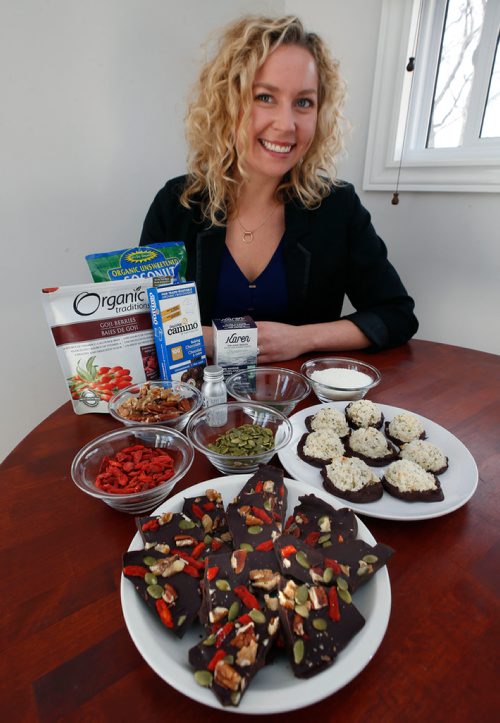 WAYNE GLOWACKI / WINNIPEG FREE PRESS

Food. Sarah Rehill in her kitchen with her Chocolate Dipped Macaroons and Superfood Nutbark in forground and some of the ingredients used.
 Wendy King Story  Nov. 27  2017