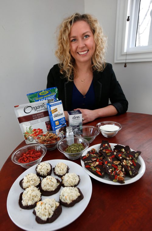 WAYNE GLOWACKI / WINNIPEG FREE PRESS

Food. Sarah Rehill in her kitchen with her Chocolate Dipped Macaroons at left, and Superfood Nutbark and some of the ingredients used.
 Wendy King Story  Nov. 27  2017