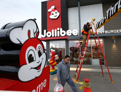 WAYNE GLOWACKI / WINNIPEG FREE PRESS

The Jollibee restaurant location at the Northgate Shopping Centre on McPhillips Street opened Tuesday at 7A.M. Jollibee, the largest fast-food chain in the Philippines now has two locations in Winnipeg. The line up began 10P.M. Monday and aprox. 75 gathered by the time the restaurant opened. Heaters in large tents were provided for the serious Jollibee  customers. Nov. 28  2017
