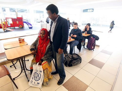 PHIL HOSSACK / WINNIPEG FREE PRESS  -  Marcos Askar welcomes his aunt  Badar Asha Askar (60) to Winnipeg Tuesday as she rests while other family gather up luggage after a 36 hr journey to Winnipeg. Marcos says he's not seen the family martriarch for 26 yrs. She and 8 other members of his clan arrivied at Winnipeg's Richardson International Airport Tuesday. Jane Gerster story.   - November 28, 2017
