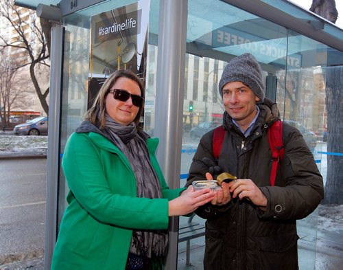 BORIS MINKEVICH / WINNIPEG FREE PRESS
A coalition of Winnipeg groups is launched the Sardine Award campaign at the corner of Donald and Broadway to draw attention to the dire state of Winnipeg Transit in the wake of a massive fare increase and significant planned service cuts announced in Mayor Brian Bowmans 2018 budget, which goes to vote on December 12th. From left, Winnipeg Labour Council president Basia Sokal and Josh Brandon, Community Animator at Social Planning Council of Winnipeg, with a can of sardines. ERIK PINDERA STORY Nov. 30, 2017