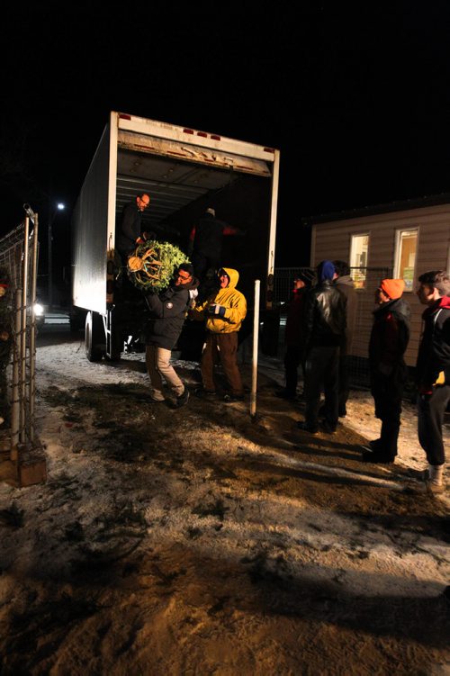 RUTH BONNEVILLE / WINNIPEG FREE PRESS

Volunteers unload Christmas trees at Deer Lodge Golf Course Thursday evening.  A portion of the funds raised from the sale of the trees go to First Kirkfield Scouting Group &  Wpg. Optimists Athletics Running Club which the volunteers are a part of.
Standup photo



Nov 30, 2017