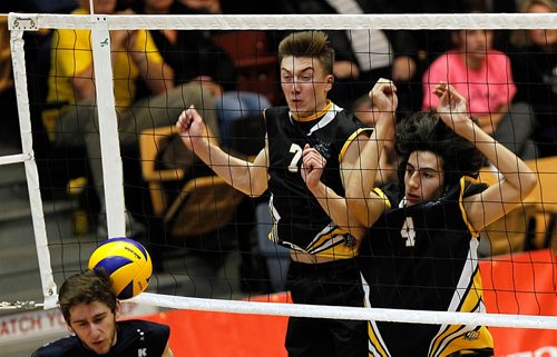 PHIL HOSSACK / WINNIPEG FREE PRESS  -  Dakota Lancers #7 Nathan Dyck and #4 Justin Stecher watch the ball they blocked bounce off River East Kodiak spiker #5 Liam Fergus's head Thursday evening in MHSAA playoff action at the Investor's Group Athletic Centre. Jason Bell Story. - November 30, 2017