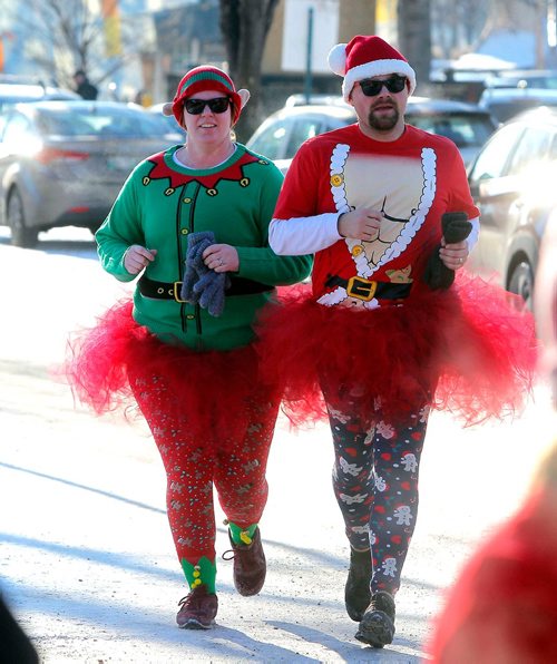 BORIS MINKEVICH / WINNIPEG FREE PRESS
The annual 5K Santa Shuffle Fun Run at The Forks brings families and friends together. The event is held across North America to help The Salvation Army to assist families and individuals in need during the Christmas season and throughout the year. From left, Hannah and Troy Nelson are married and do the run for the first time. There were 530 entries in the race. STANDUP PHOTO  Dec. 2, 2017