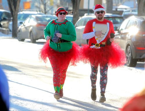 BORIS MINKEVICH / WINNIPEG FREE PRESS
The annual 5K Santa Shuffle Fun Run at The Forks brings families and friends together. The event is held across North America to help The Salvation Army to assist families and individuals in need during the Christmas season and throughout the year. From left, Hannah and Troy Nelson are married and do the run for the first time. There were 530 entries in the race. STANDUP PHOTO  Dec. 2, 2017