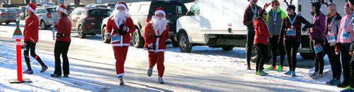 BORIS MINKEVICH / WINNIPEG FREE PRESS
The annual 5K Santa Shuffle Fun Run at The Forks brings families and friends together. The event is held across North America to help The Salvation Army to assist families and individuals in need during the Christmas season and throughout the year. From left dressed as santa claus', Amanda Wrubleski and her mom Anita Wrubleski. There were 530 entries in the race. STANDUP PHOTO  Dec. 2, 2017