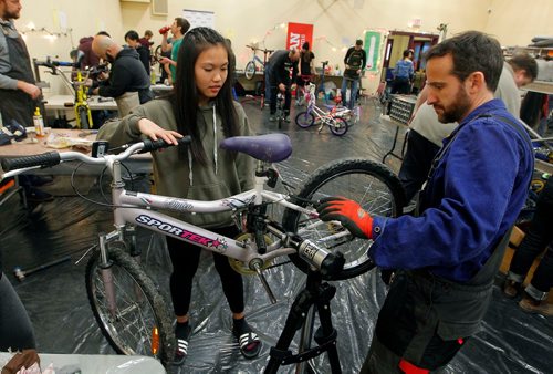 BORIS MINKEVICH / WINNIPEG FREE PRESS
From left, Hugh John MacDonald School grade 9 student Tenderly Tenderly work with bike mechanic Richard Helbig work on a bike at the 24-hour kids' bike-building marathon. The event from noon Saturday to noon Sunday, at the Orioles Community Centre at 448 Burnell St. Over 350 volunteers of which there were 150 bike mechanics were involved. The goal is to build over 300 bikes in 24hrs. The WRENCH program organized it. STANDUP PHOTO  Dec. 2, 2017

Tenderly Tenderly is her name. Triple checked.