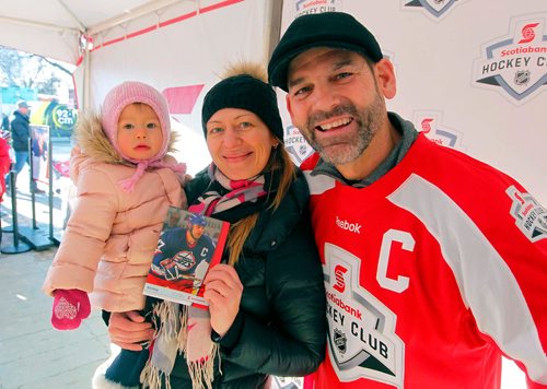 BORIS MINKEVICH / WINNIPEG FREE PRESS
The Rogers Hometown Hockey Tour at the Forks. From left, 18 month old Veronica Minkin with her mom Natalya get an autograph signed by old Winnipeg Jets player Kris King at the event. STANDUP PHOTO  Dec. 2, 2017