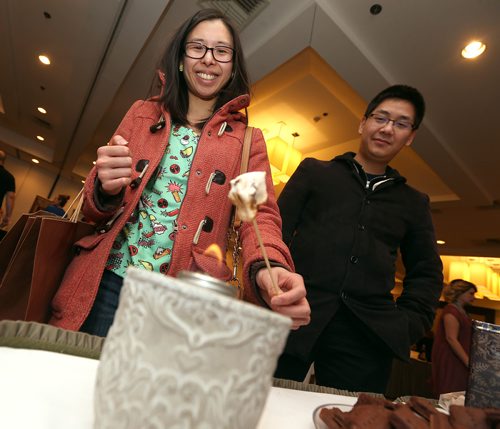 JASON HALSTEAD / WINNIPEG FREE PRESS

Nick Au watches as his friend Damaris Tan toasts her marshmallow from Maria's Marshmallows at the Canadian Cancer Societys second annual Everything Chocolate Event on Nov. 17, 2017 at the Hilton Winnipeg Airport Suites. (See Social Page)
