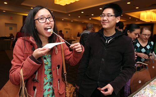 JASON HALSTEAD / WINNIPEG FREE PRESS

Nick Au watches as his friend Damaris Tan enjoys her toasted marshmallow from Maria's Marshmallows at the Canadian Cancer Societys second annual Everything Chocolate Event on Nov. 17, 2017 at the Hilton Winnipeg Airport Suites. (See Social Page)