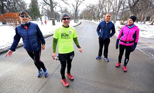 TREVOR HAGAN / WINNIPEG FREE PRESS
Retired teacher, Michael Bennett, second from left, planned to raise $3000 for Art City as he ran 58.241km's looping around Wellington Crescent and Wolesely, Sunday, December 3, 2017.