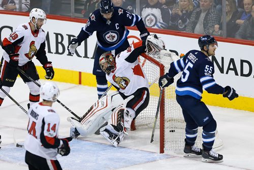 JOHN WOODS / WINNIPEG FREE PRESS
The puck goes under the goal as it is pushed off it's moorings by Ottawa Senators goaltender Craig Anderson (41) during third period NHL action against the Winnipeg Jets in Winnipeg on Sunday, December 3, 2017.
