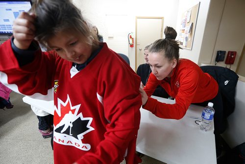 JOHN WOODS / WINNIPEG FREE PRESS
Team Canada hockey players  Jocelyne Larocque (r), Bailey Bram (c), and Brigette Lacquette (not seen) signed their autographs on Orieanna Kennedy's shirt in St Anne Monday, December 4, 2017. Canada plays the USA tomorrow in Winnipeg