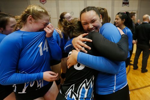 JOHN WOODS / WINNIPEG FREE PRESS
College Jeanne-Sauve Olympiens' Cierra Cyr (35)(R) embraces Jenna Campbell (55) as they celebrate defeating the Portage Collegiate Saints in the 2017 Manitoba High Schools Athletic Association AAAA Provincial High School Volleyball Championships at the University of Manitoba Monday, December 4, 2017.