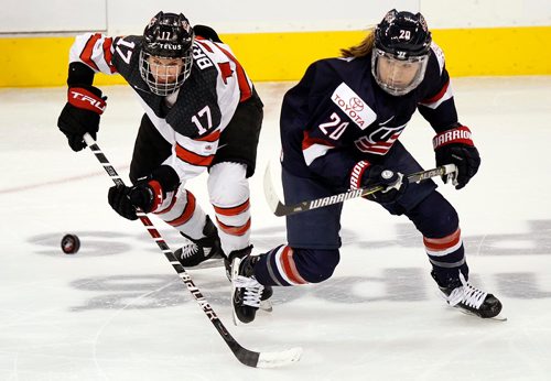 PHIL HOSSACK / WINNIPEG FREE PRESS  - Team Canada #17 Bailey Bram drives for the puck against USA's #20 Hannah Brandt at Bell MTS Place Tuesday evening. See story.. -  December 5, 2017