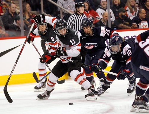 PHIL HOSSACK / WINNIPEG FREE PRESS  - Team Canada #11Jillin Saulner drives for the puck against USA's #10Meghan Duggan and #25 Alex Carpenter at MTS Place Tuesday evening. See story.. -  December 5, 2017