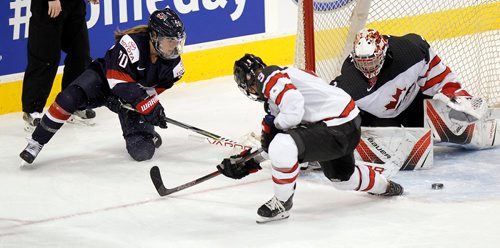 PHIL HOSSACK / WINNIPEG FREE PRESS  - Team USA #20 Hannah BRant tries unsuccessfully to sweep the puck around Canada netminder #31 Genevieve Lacasse in the third period at MTS Place Tuesday evening. #9 Jennifer Wakefield offers a leg. See story.. -  December 5, 2017