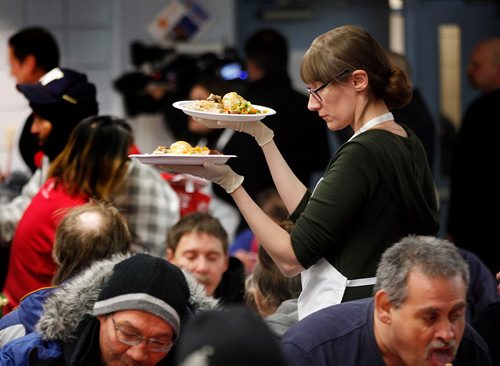 PHIL HOSSACK / WINNIPEG FREE PRESS  - Christine West serves up a pair of plates full of Christmas dinner as hungry participants file in for the annual Salvation Army Christmas Dinner. Over 1000 were served last Christmas, the Sally Anne cooks were prepped for 1200 this year and were dishing it out to 150 at each sitting. See release. -  December 6, 2017