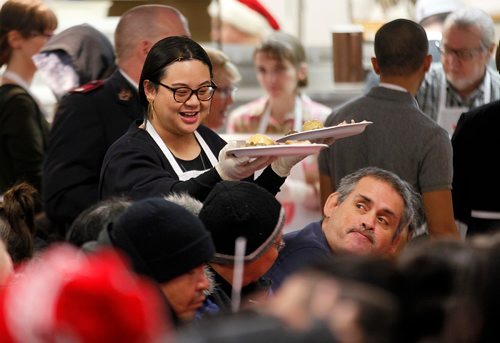 PHIL HOSSACK / WINNIPEG FREE PRESS  - Miriam Delos Santos serves up a pair of plates full of Christmas dinner as hungry participants file in for the annual Salvation Army Christmas Dinner. Over 1000 were served last Christmas, the Sally Anne cooks were prepped for 1200 this year and were dishing it out to 150 at each sitting. See release. -  December 6, 2017