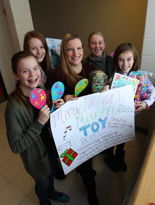 RUTH BONNEVILLE / WINNIPEG FREE PRESS

Henry G. Izatt Middle School Teacher Kathy Stardom (centre), and some of her Grade 7 Math and Science class students have been busy gathering new toys for our Miracle on Mountain for Christmas Cheer Board.  

Names of students: Abby MacInnes (left, with barbie), Kaylee McMannes (blue), Veronica Sokolov and Alaina Simpson (right, in purple).  



The whole class is busy gathering new toys for our Miracle on Mountain tree!


This photo is for Kevin's column.   
Kevin Rollason  | Reporter 
Dec 0/7, 2017