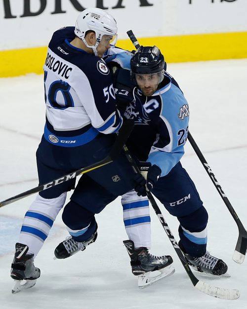 JOHN WOODS / WINNIPEG FREE PRESS
Manitoba Moose Jack Roslovic  (50) and Milwaukee Admirals' Trevor Smith (23) fight for position during first period AHL action in Winnipeg on Sunday, December 10, 2017.