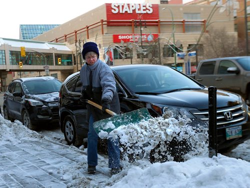 WAYNE GLOWACKI / WINNIPEG FREE PRESS

Judy Weselowski owner of ¤the Book Fair on Portage Ave. clears away the snow Monday morning that fell overnight.¤  weather story  Dec. 11  2017