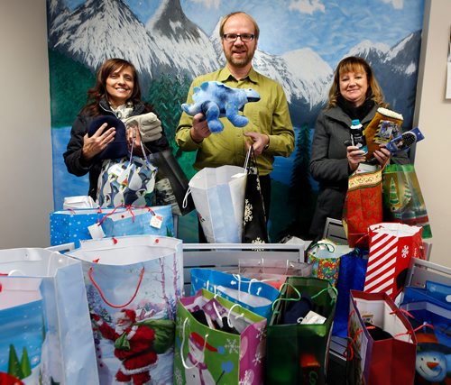 WAYNE GLOWACKI / WINNIPEG FREE PRESS

Frank Ulrich, executive director of the Union Gospel Mission with gift bags donated by the Winnipeg Free Press and delivered Monday to the Mission on  Princess St. by advertising executives Karen Buss, Director, at right, and Sandra Sampson, Sales Coordinator. The mission sent out a call for the public to help fill gifts bags for the needy in the area and the Free Press filled and delivered bags for 10 men, 10 ladies, 5 boys and 5 girls. The Union Gospel Mission hands out gifts to everyone who comes to their Christmas Dinner, Street Ministry and other programs. They are looking for gifts for 300 men, 200 women, and 100 children. Items needed for an adult include  razors & shaving cream, shampoo & conditioner, toothpaste & toothbrush, comb or brush,deodorant, Bible,Christian book or CD, socks, hats,¤gloves & scarves. For Children: a new unwrapped toy, new teddy bear, Bible, hats, mitts & scarves, Christian book or CD. Label the gifts for 'man''woman''boy' or 'girl'. They can be placed in small to medium gift bags, shoe boxes, draw string bags or back packs and dropped off at the Mission.  Dec. 11  2017