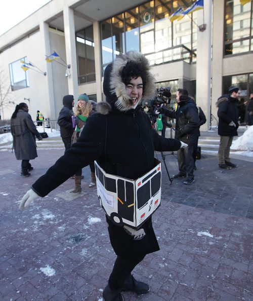 RUTH BONNEVILLE / WINNIPEG FREE PRESS

FIGHTING FARE HIKE:  Annie Beach cones a cardboard bus around her waist as she rally's with others  in support of Winnipeg Transit outside City Hall Monday.  
Maggie MacIntosh (intern)

Dec 11, 2017