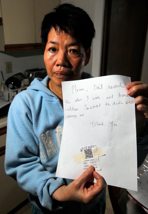 BORIS MINKEVICH / WINNIPEG FREE PRESS
Cathy Wong holds a note with her concerns and fears with the use of her name and workplace with the expired transit bus transfer from the day of the alleged racist harassment from a bus driver. The 61-year-old Chinese Canadian hotel worker was on her way to work Saturday when she says she was treated rudely by the bus driver and told Go back to where you came from and wasnt allowed off the bus at her stop. For Carol Sanders story. Dec. 12, 2017
