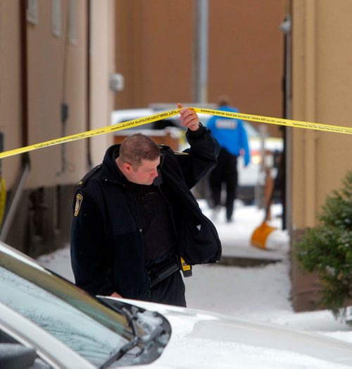 BORIS MINKEVICH / WINNIPEG FREE PRESS
Police goes under the police tape at police shooting scene at 481 Charles St. Dec. 12, 2017