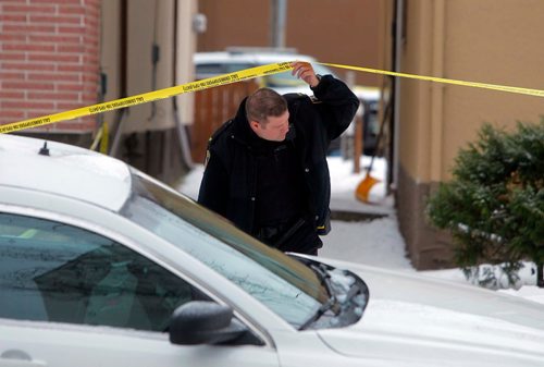 BORIS MINKEVICH / WINNIPEG FREE PRESS
Police goes under the police tape at police shooting scene at 481 Charles St. Dec. 12, 2017