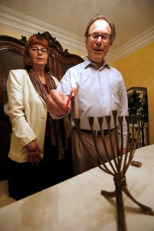JOHN WOODS / WINNIPEG FREE PRESS
Chaya and Rabbi Alan Green light a menorah for Chanukah in their home Tuesday, December 12, 2017. This is Rabbi Green's last Chanukah in Winnipeg as he is retiring from the Shaarey Zedek Synagogue in March after 17 years with the congregation.