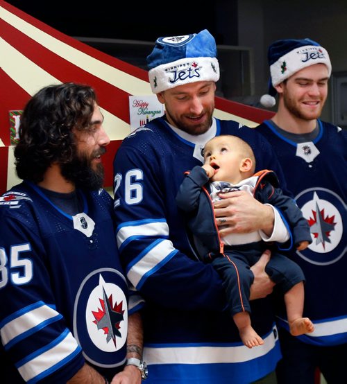 WAYNE GLOWACKI / WINNIPEG FREE PRESS

Seven players from the Winnipeg Jets met with young patients at HSC Children's Hospital Wednesday afternoon on their annual Christmas time visit.  Here Jets Captan Blake Wheeler holds one year old Carson beside players Mathieu Perreault,left, and Adam Lowry. The players also visited patients in the wards and made an appearance on CHTV, the hospitals closed-circuit television station.  Dec. 13  2017