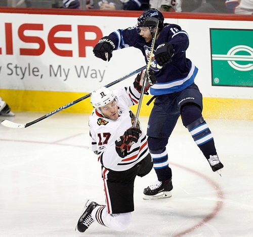 PHIL HOSSACK / WINNIPEG FREE PRESS  - Winnipeg Jet #18 Bryan Little and Chicago Blackhawk # 17 collide Thursday at Bell MTS Place.  - December 14, 2017